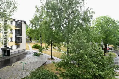 a view of a park with trees and a building at Relax Inn Druskininkai in Druskininkai