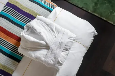 a white towel sitting on top of a bed at The Joseph in Vilnius