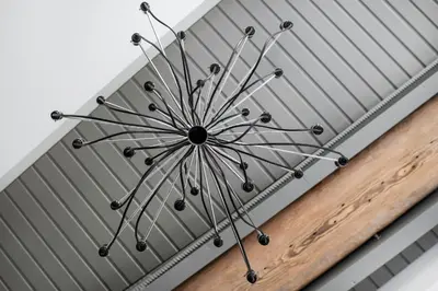 a metal chandelier hanging from a ceiling at The Joseph in Vilnius