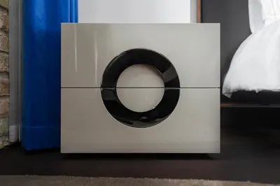 a white dresser with a black circle on it at The Joseph in Vilnius
