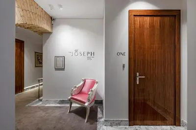 a room with a chair and a wooden door at The Joseph in Vilnius