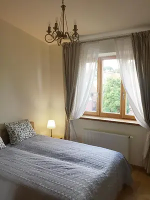 a bedroom with a bed and a window at Nemunas Street Apartment in Kaunas