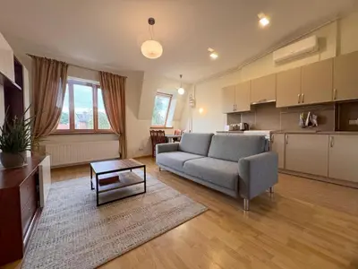a living room with a couch and a table at Nemunas Street Apartment in Kaunas