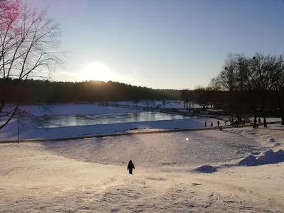 a person walking through a snow covered field at Atostogų namai in Druskininkai