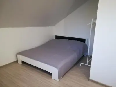 a small bedroom with a bed in a room at Atostogų namai in Druskininkai