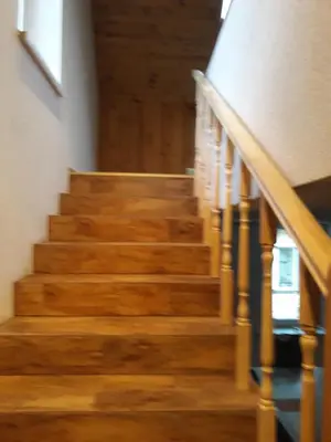 a stairway in a building with wooden stairs at Alyvos in Ignalina