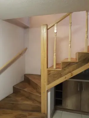 a staircase in a house with wooden steps at Alyvos in Ignalina