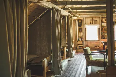 a room with a bed and a chair and a window at Pagulbis - Tavo namai in Klabiniai