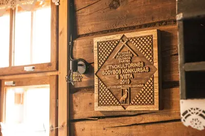 a sign on the wall of a building at Pagulbis - Tavo namai in Klabiniai