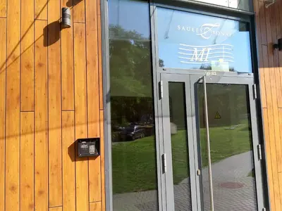 a glass door of a building with a sign on it at Chocolate Apart in Druskininkai