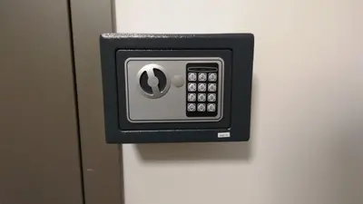 a black and silver alarm clock on a wall at Chocolate Apart in Druskininkai