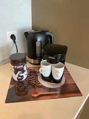 a counter with two coffee cups and a coffee maker at Chocolate Apart in Druskininkai