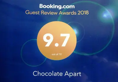a sign that says guest review awards with a circle at Chocolate Apart in Druskininkai