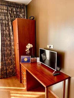 a wooden desk with a television on top of it at Chocolate Apart in Druskininkai