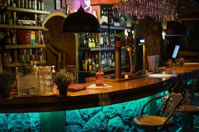 a bar with a wooden counter in a room at Hotel Vaidila in Alytus