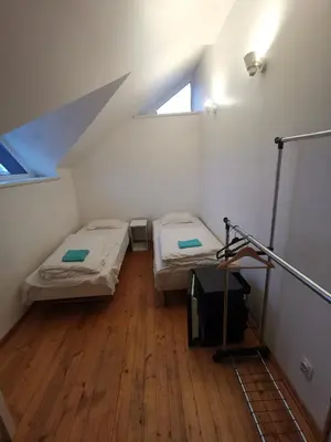 two beds in a small room with a window at A&L private rooms in Kaunas in Kaunas