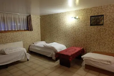a room with two beds and a table in it at A&L private rooms in Kaunas in Kaunas