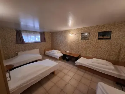 a room with three beds and a desk in it at A&L private rooms in Kaunas in Kaunas