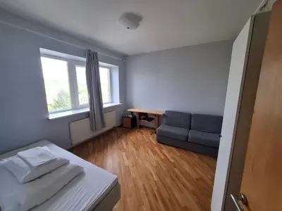 a room with a bed and a couch and a window at A&L private rooms in Kaunas in Kaunas