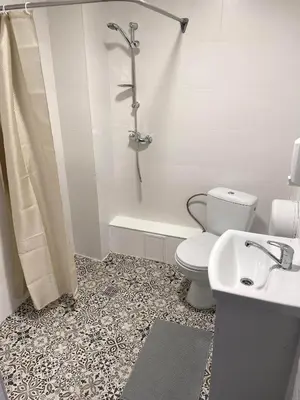 a bathroom with a toilet and a shower and a sink at Rezidencija 