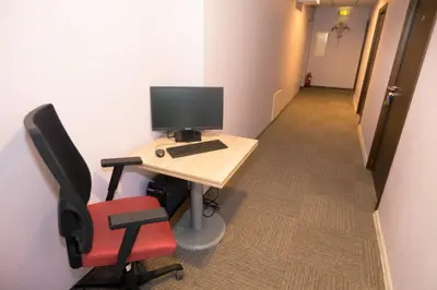 an office with a desk with a computer and a chair at Rezidencija 