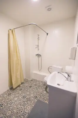 a bathroom with a shower and a toilet and a sink at Rezidencija 