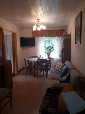 a living room with a couch and a table at Česlovos sodyba in Zarasai