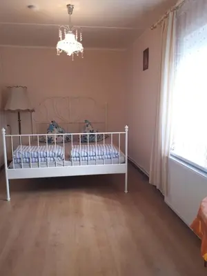 a white bed in a room with a window at Česlovos sodyba in Zarasai