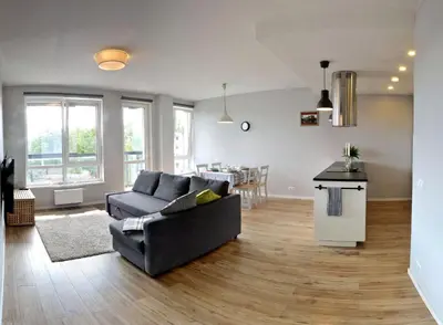 a living room with a couch and a table at Dzuku apartment 40 in Vilnius