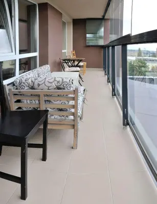 a room with a couch and a table and windows at Dzuku apartment 40 in Vilnius