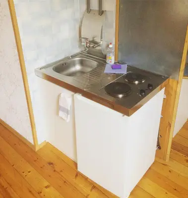 a small kitchen with a sink and a counter at Jolando Apartment in Kaunas