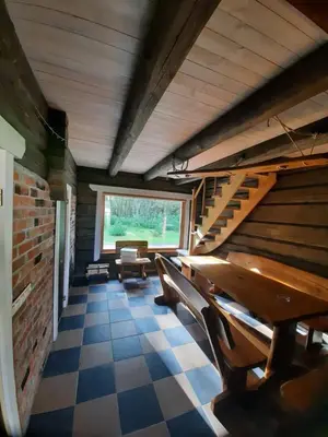 a room with benches and stairs in a building at Escape of city in Pabiržė