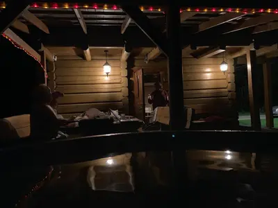 a group of people sitting in a living room at night at Escape of city in Pabiržė