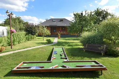 a picnic table in the grass in a park at Vasarnamis Zarasuose in Zarasai