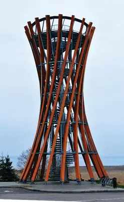 a tall metal sculpture sitting on the side of a road at Vivaldi Lake House in Meteliai