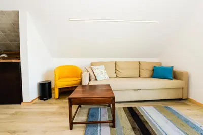 a living room with a couch and a coffee table at Vivaldi Lake House in Meteliai