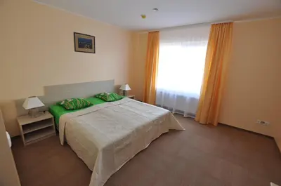 a bedroom with a bed and a large window at Motel Paradise in Vilnius