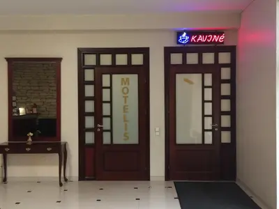 two doors in a room with a sign on the wall at Motel Paradise in Vilnius