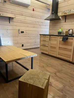 a kitchen with a table and a bench in a room at Vila Rica in Ricieliai