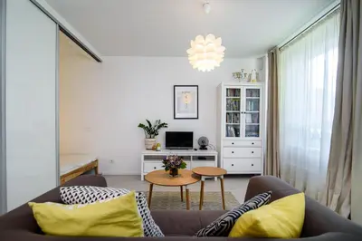 a living room with a couch and a table at #stayhere - Comfy & Stylish Studio with Green Patio close to Old Town in Vilnius