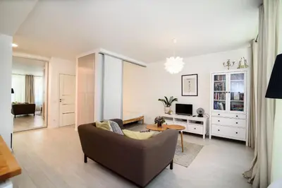 a living room with a couch and a table at #stayhere - Comfy & Stylish Studio with Green Patio close to Old Town in Vilnius