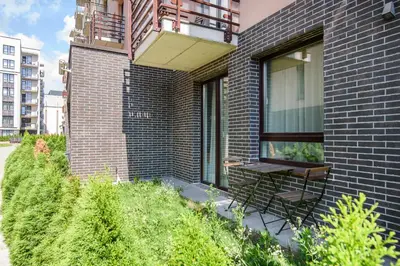 a bench sitting on the side of a brick building at #stayhere - Comfy & Stylish Studio with Green Patio close to Old Town in Vilnius