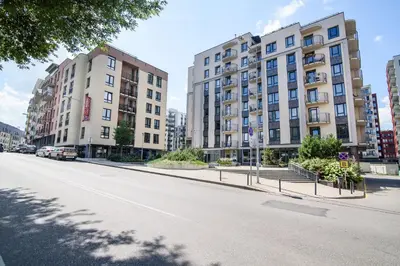 an empty street in a city with tall buildings at #stayhere - Comfy & Stylish Studio with Green Patio close to Old Town in Vilnius