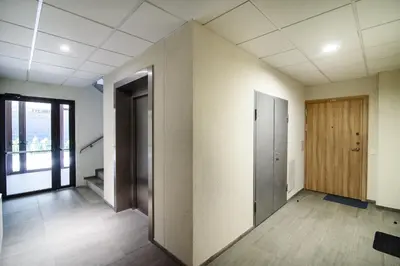 an empty hallway of an office building with a door at #stayhere - Comfy & Stylish Studio with Green Patio close to Old Town in Vilnius