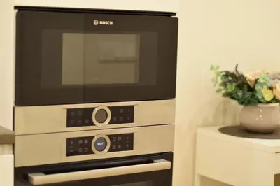 a microwave oven sitting on top of a stove at Europa Dream Apartment in Vilnius
