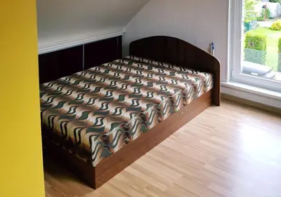 a large bed in a room with a window at Vila House in the city center of Ukmerge in Ukmergė