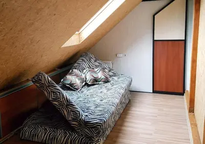 a bedroom with a bed with zebra pillows on it at Vila House in the city center of Ukmerge in Ukmergė