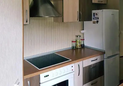 a kitchen with a white refrigerator and a stove at Vila House in the city center of Ukmerge in Ukmergė