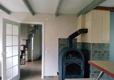 a room with a fireplace with a stove at Vila House in the city center of Ukmerge in Ukmergė