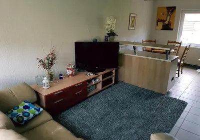 a living room with a couch and a flat screen tv at Vila House in the city center of Ukmerge in Ukmergė